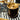 Black ice bucket with gold lid and handle on a marble surface