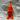 Orange gnome figurine on a spider web with spiders